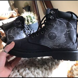 Sun and moon painted black boots.